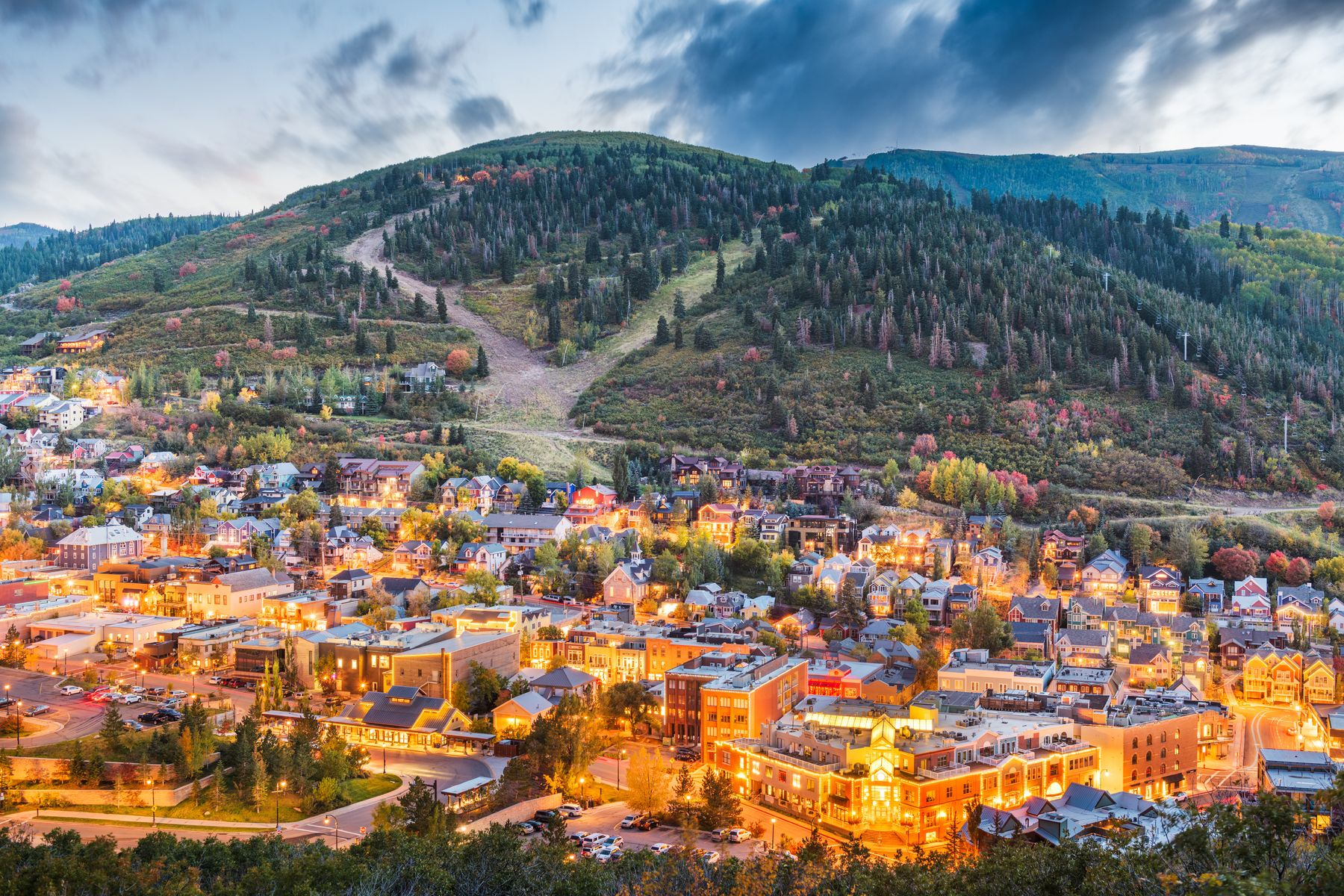Old Town Park City lit at dusk below ski runs